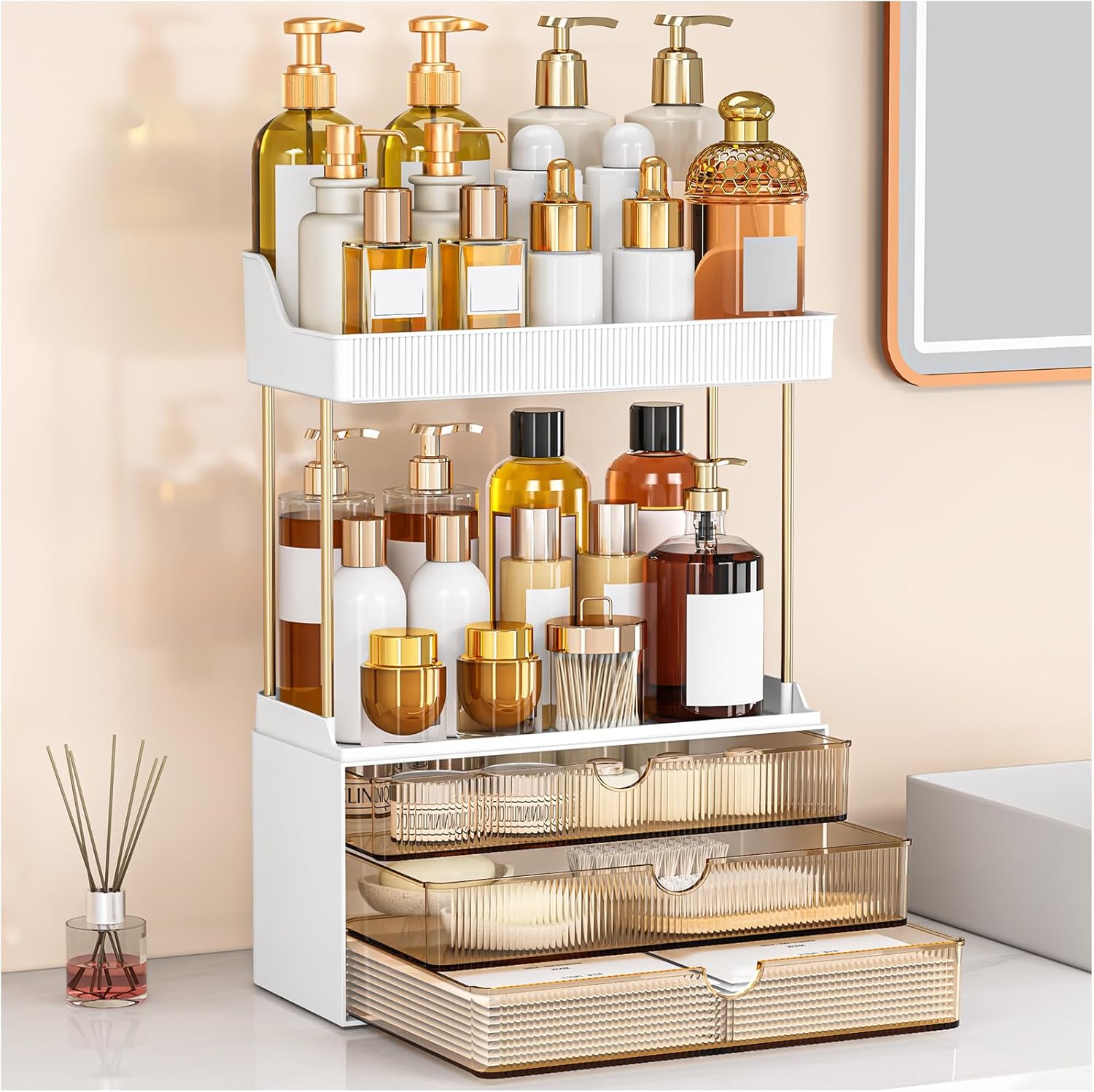 Amber tier drawer makeup organizer with multiple drawers and open shelves placed on a large vanity, organizing makeup, skincare bottles, and perfumes