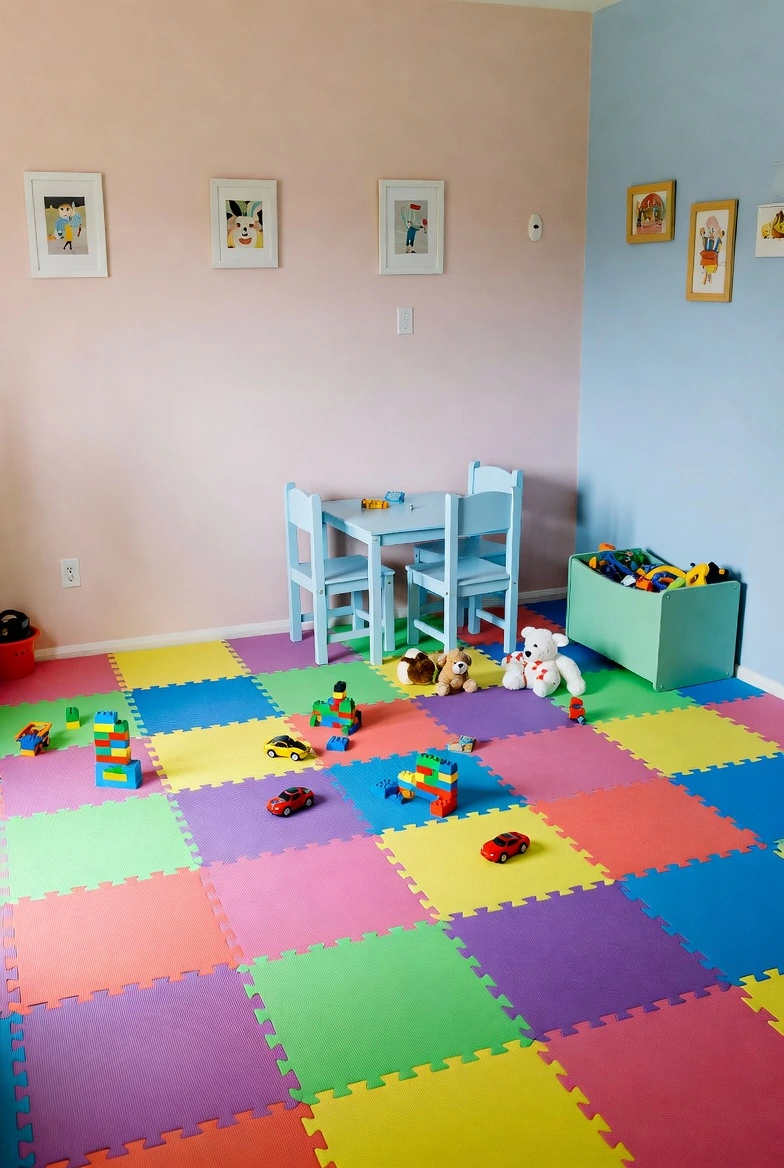 kids playroom with foam puzzle mats, bright colors, safe and soft play area, toys scattered, family friendly interior