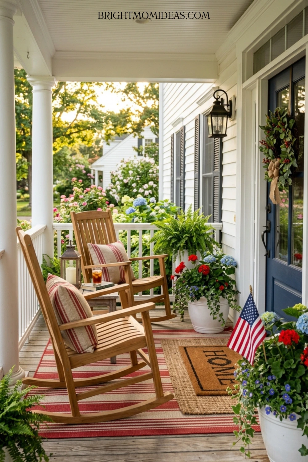 Complete classic Americana front porch with rocking 
chairs grain sack pillows striped rug and red and 
navy planters designed to last all summer
