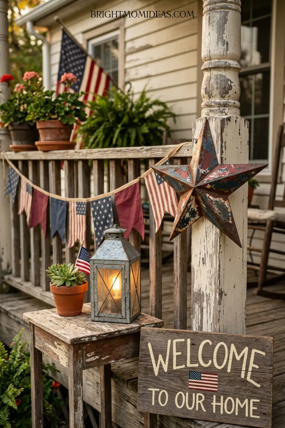 Small weathered wood welcome sign with hand painted 
serif lettering leaning against porch wall beside 
red bloom planter