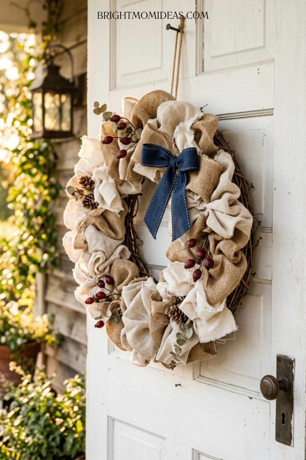All season natural textile Americana wreath with 
deep red and navy accents on cream painted front 
door