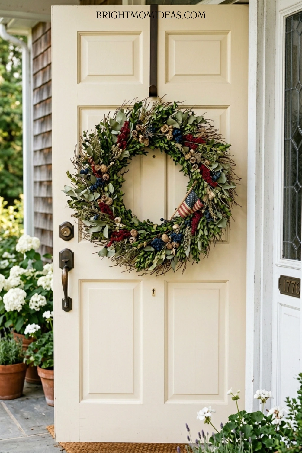 Close up of natural textile wreath with dried 
grasses brick red and navy fabric elements and 
vintage star ornament