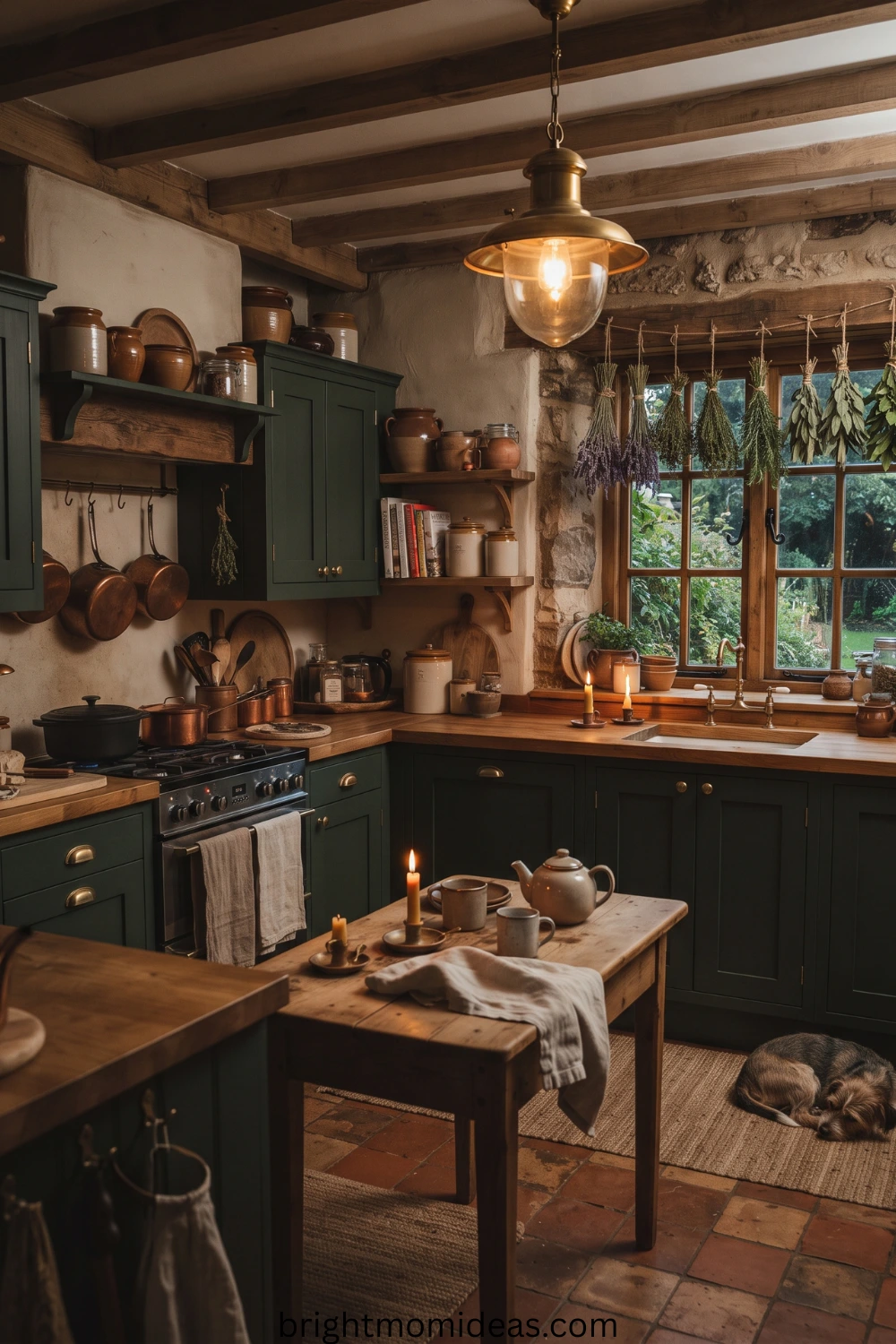 dark cottagecore kitchen with forest green cabinets and vintage pendant lighting