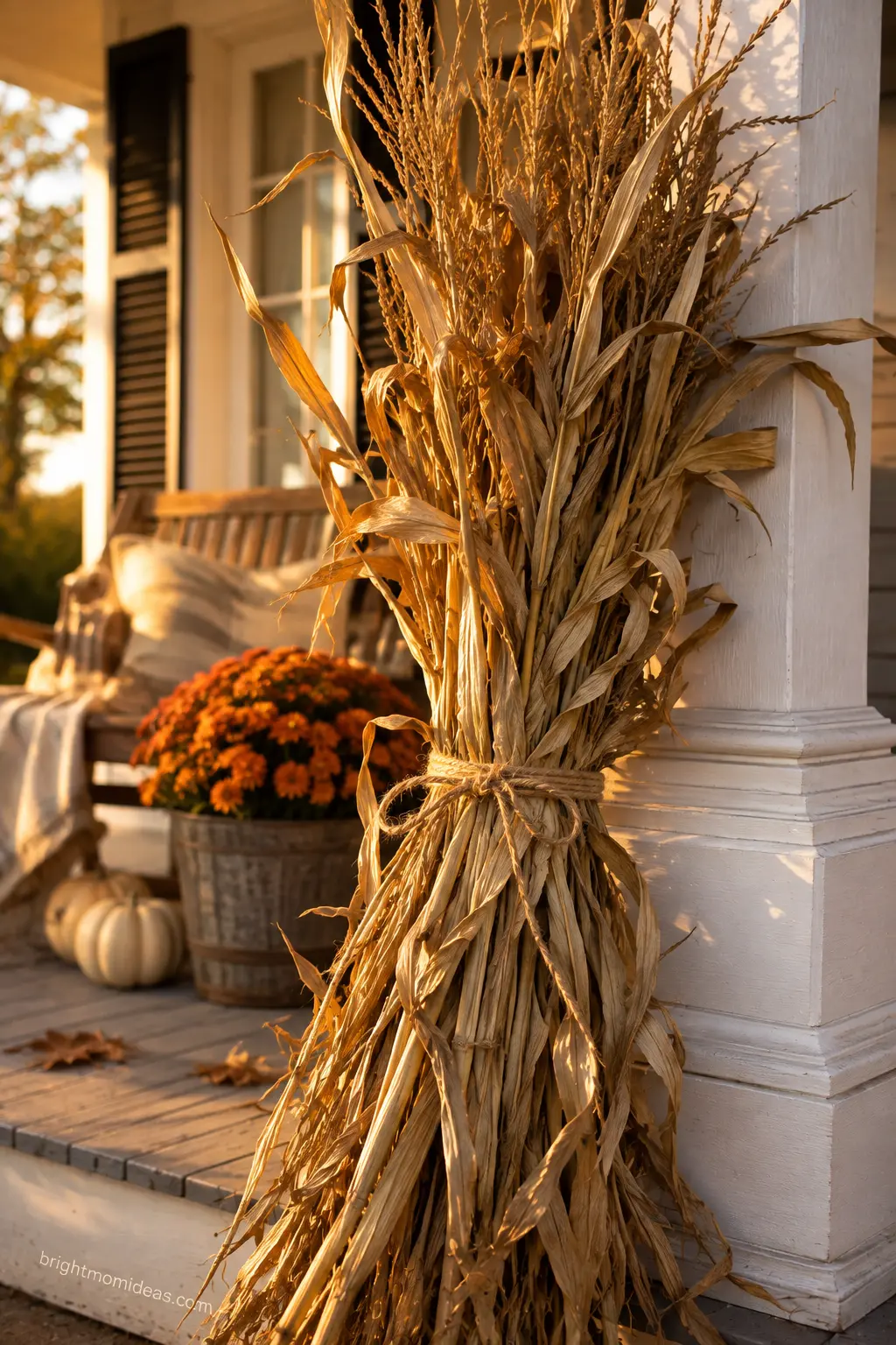 Loosely tied cornstalk bundle leaning against a porch post